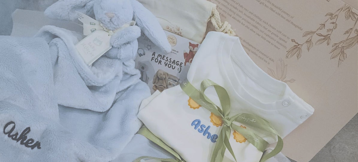 A Baby Butter gift set with a blanket and a romper embroidered with a name